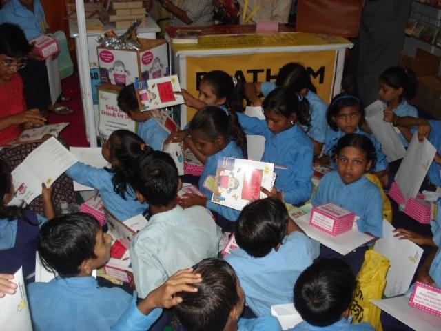 Young children reading picture books in a classroom