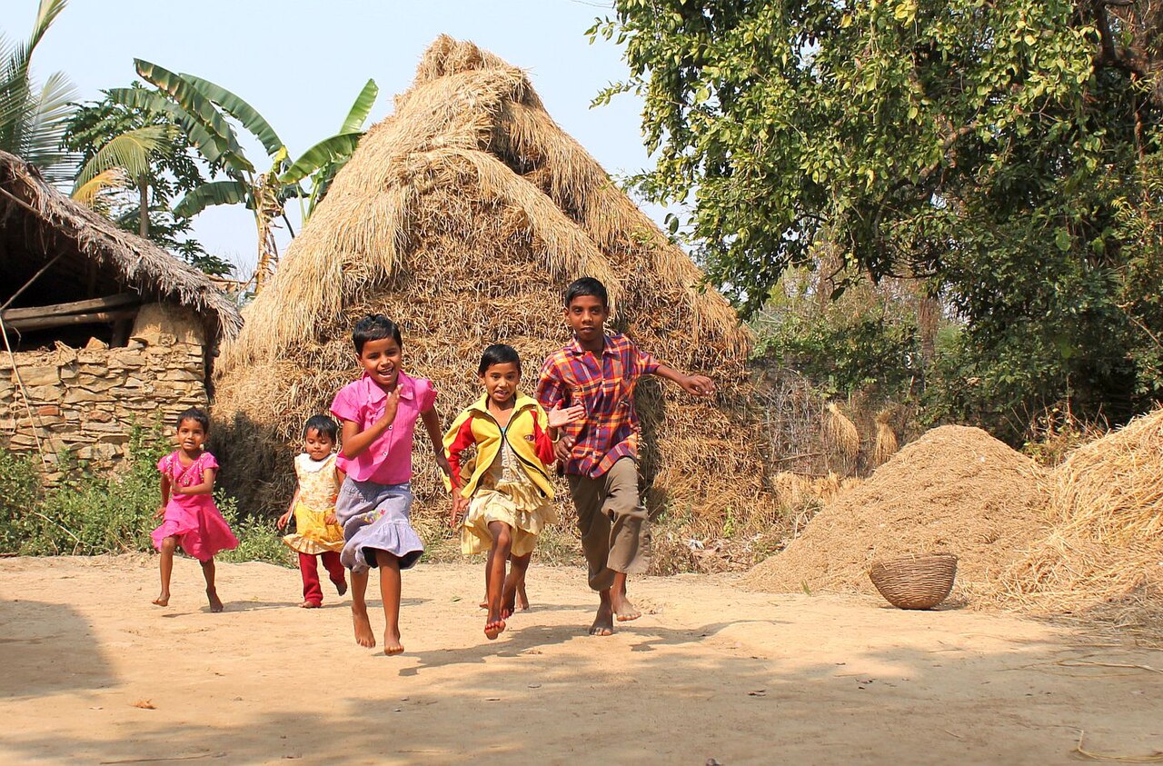 Children running and playing in their village