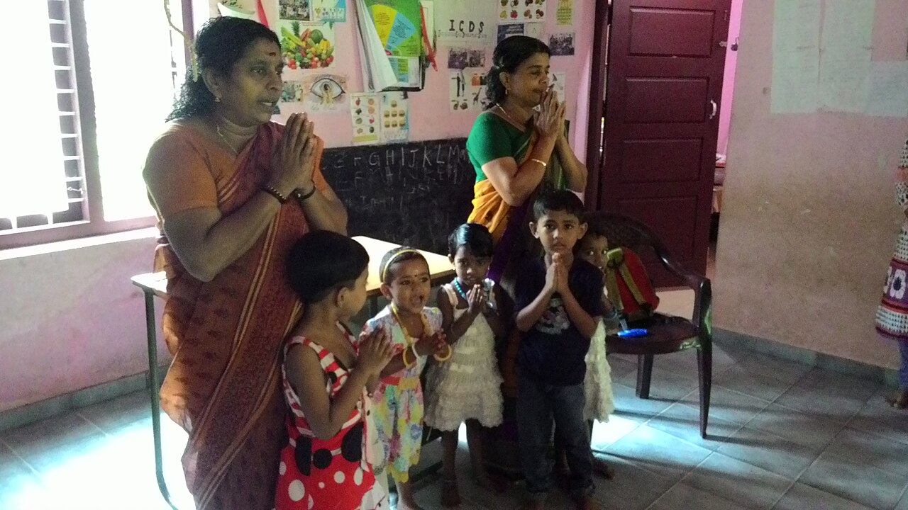 Anganwadi worker caring for young children at a community centre