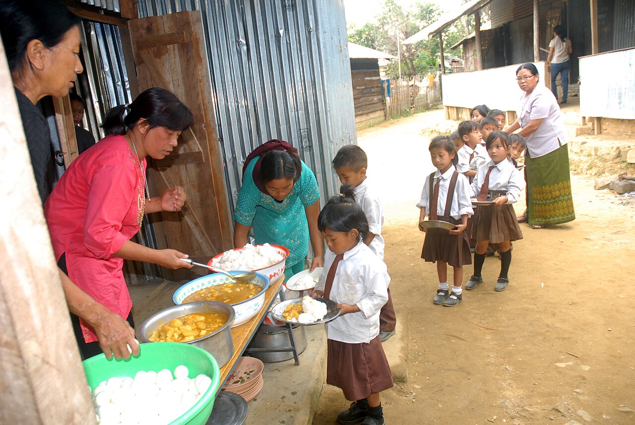 Children being served a hot meal at school