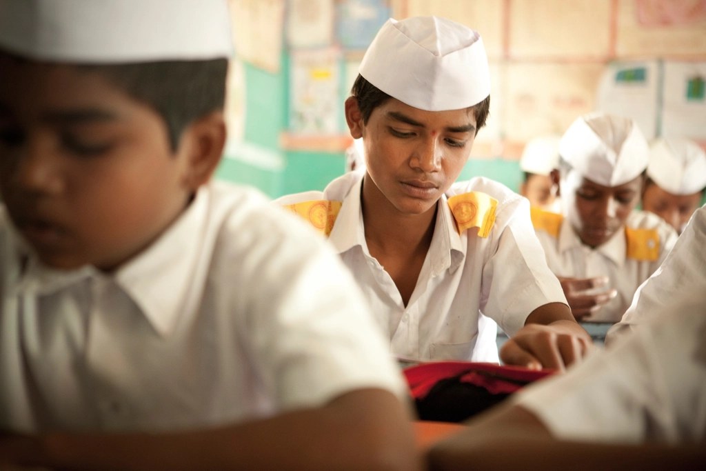 Schoolboys in uniform at their desks