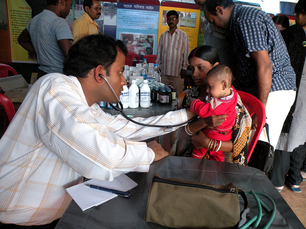 Doctor checking a child at a medical camp