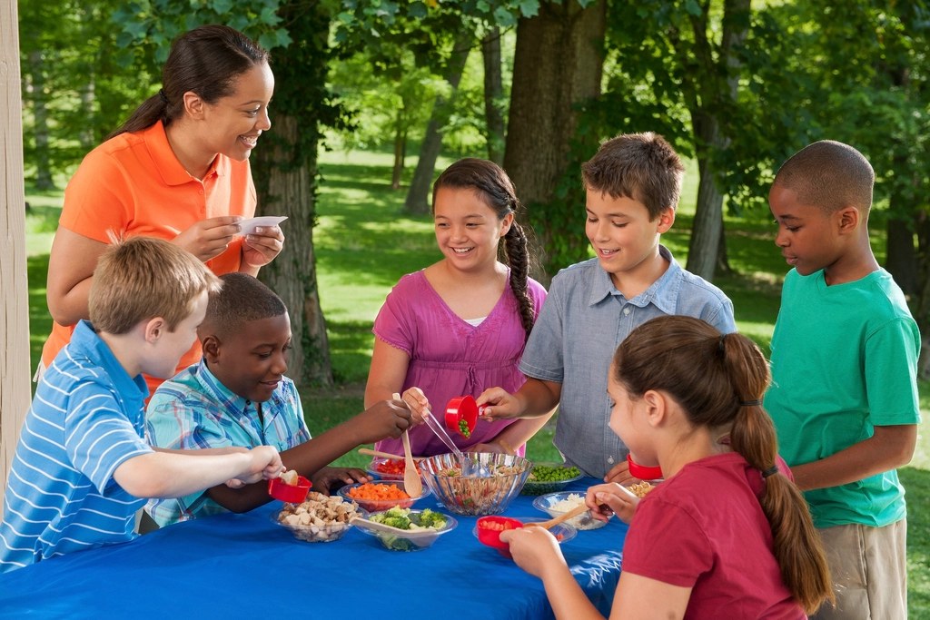 Volunteers doing a craft activity with children